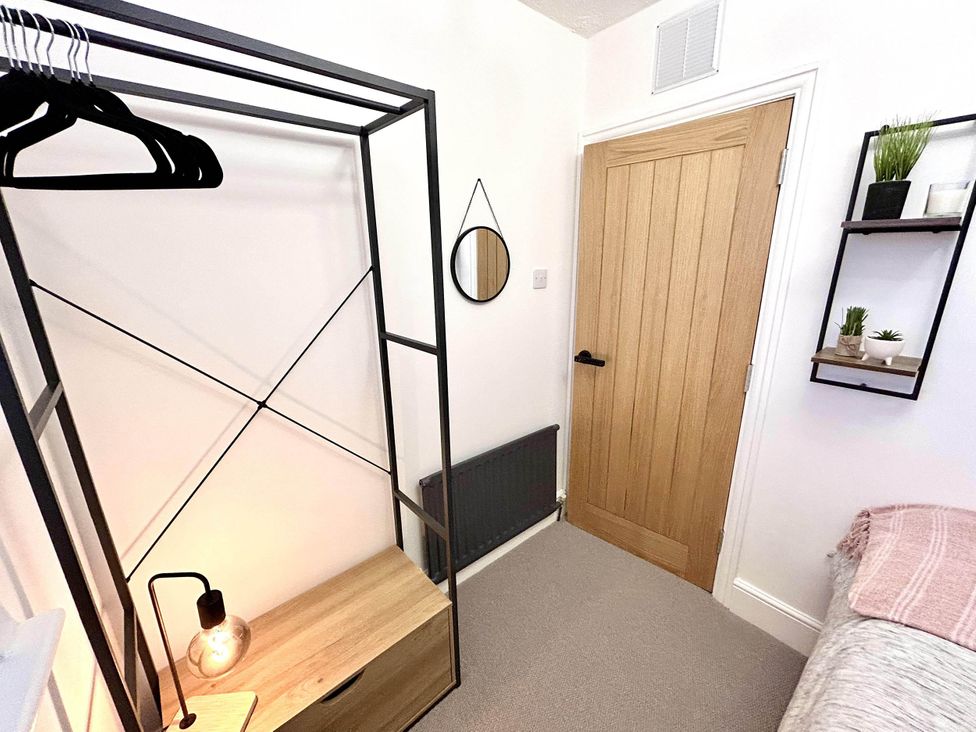 A bedroom with a clothes rack and a door at 6 Guests 3Bed House in Chester-Le-Street