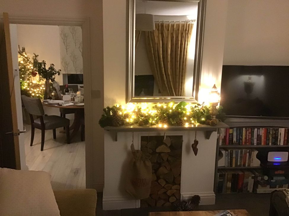 A living room with a fireplace and television at Cozy Nook boutique Cottage in Oakham