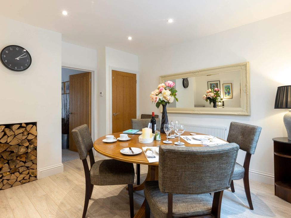 A dining room with a table set for a meal at Cozy Nook boutique Cottage in Oakham