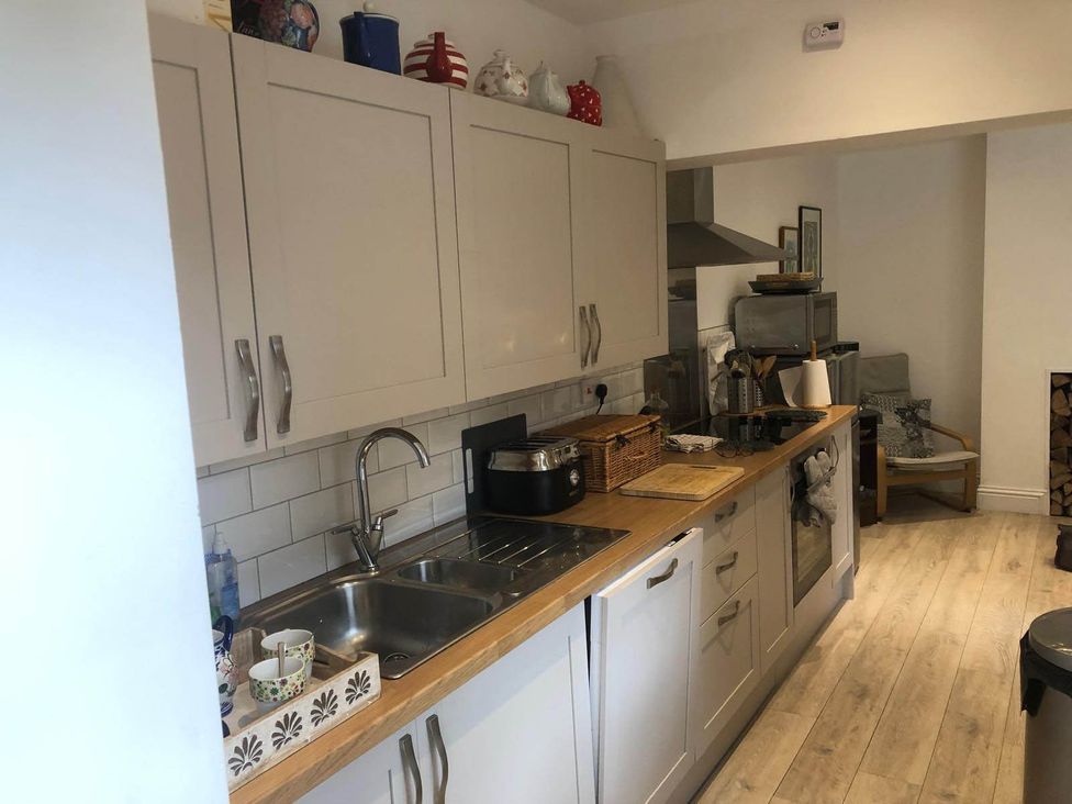 A kitchen with cabinets and countertop space at Cozy Nook boutique Cottage in Oakham