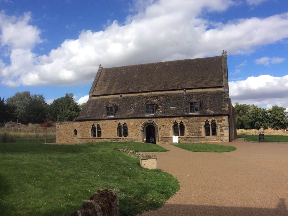 A building with a stone facade and large windows located at Cozy Nook boutique Cottage in Oakham
