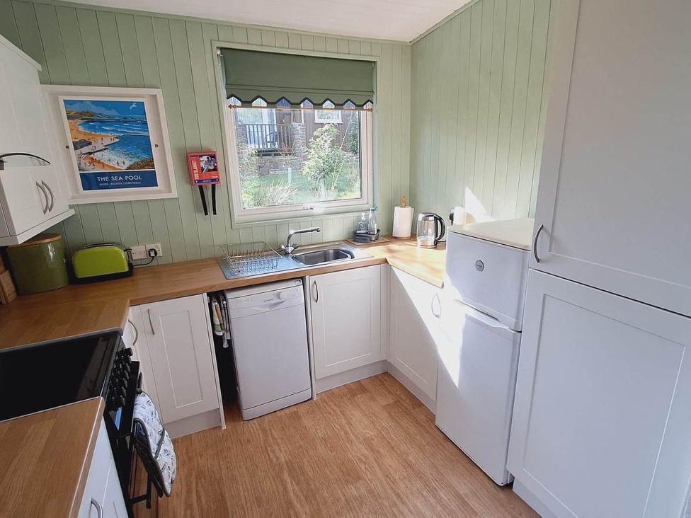 A kitchen with a sink and appliances at Forest Retreat Sleeps 4 2Bed with Parking Woolsery near Bideford