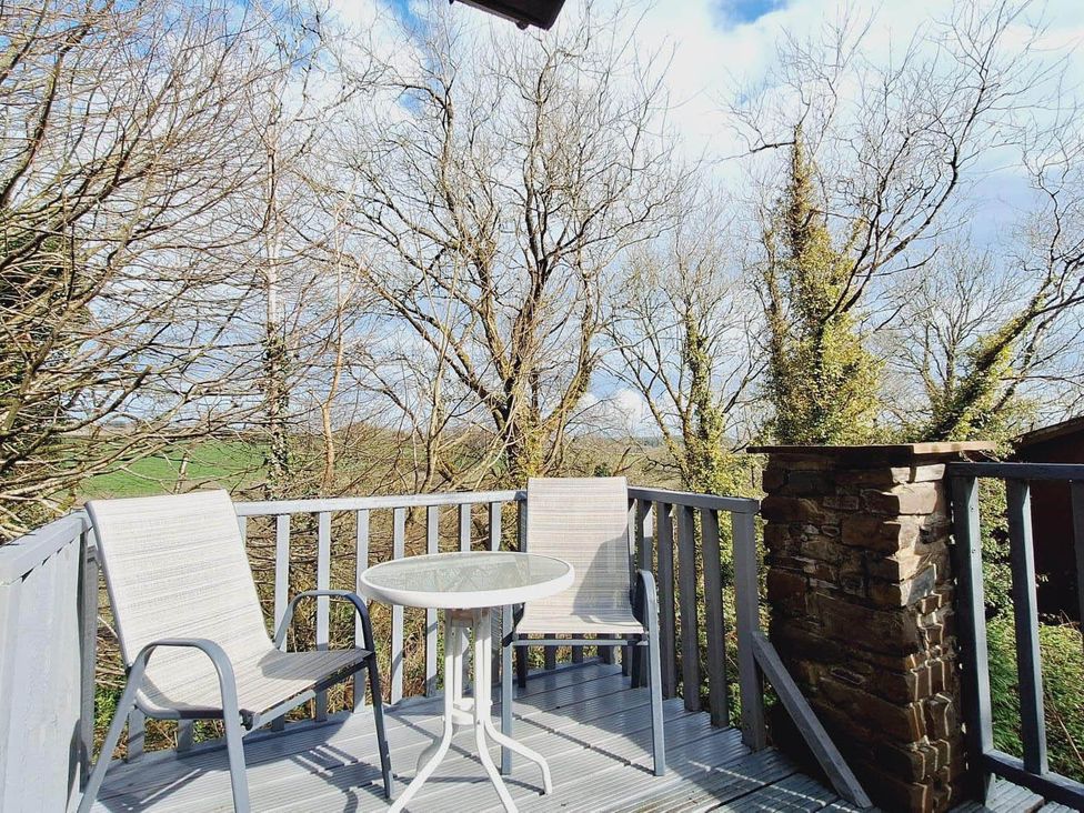 An outdoor area with a table and chairs at Forest Retreat Sleeps 4 2Bed with Parking Woolsery near Bideford