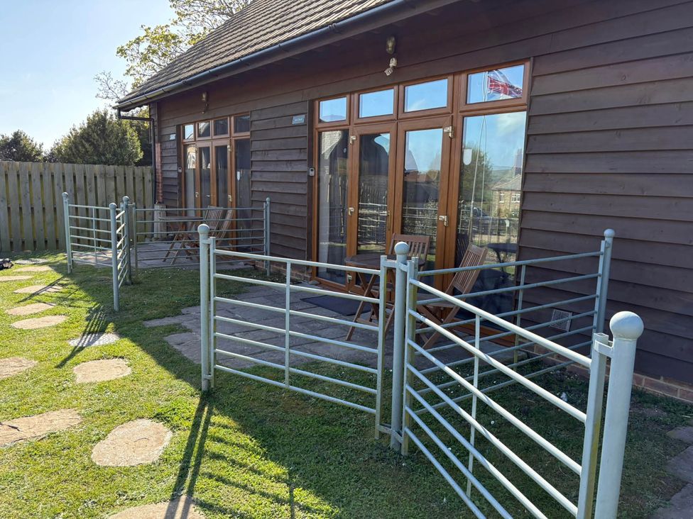 An outdoor area with a fence and seating at Farmhouse Sleeps 5 Near Alton Towers Peak District in Shorwell