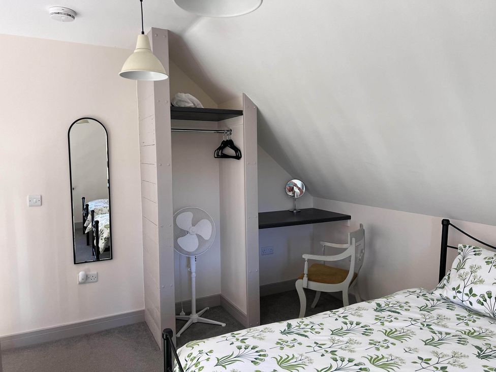 A bedroom with a bed, desk, and mirror at Farmhouse Sleeps 5 Near Alton Towers Peak District in Shorwell