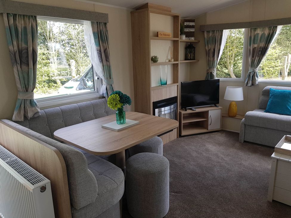 A living room with a table and sofa at Caravan Sleeps4 Pet friendly with Parking Available Skegness
