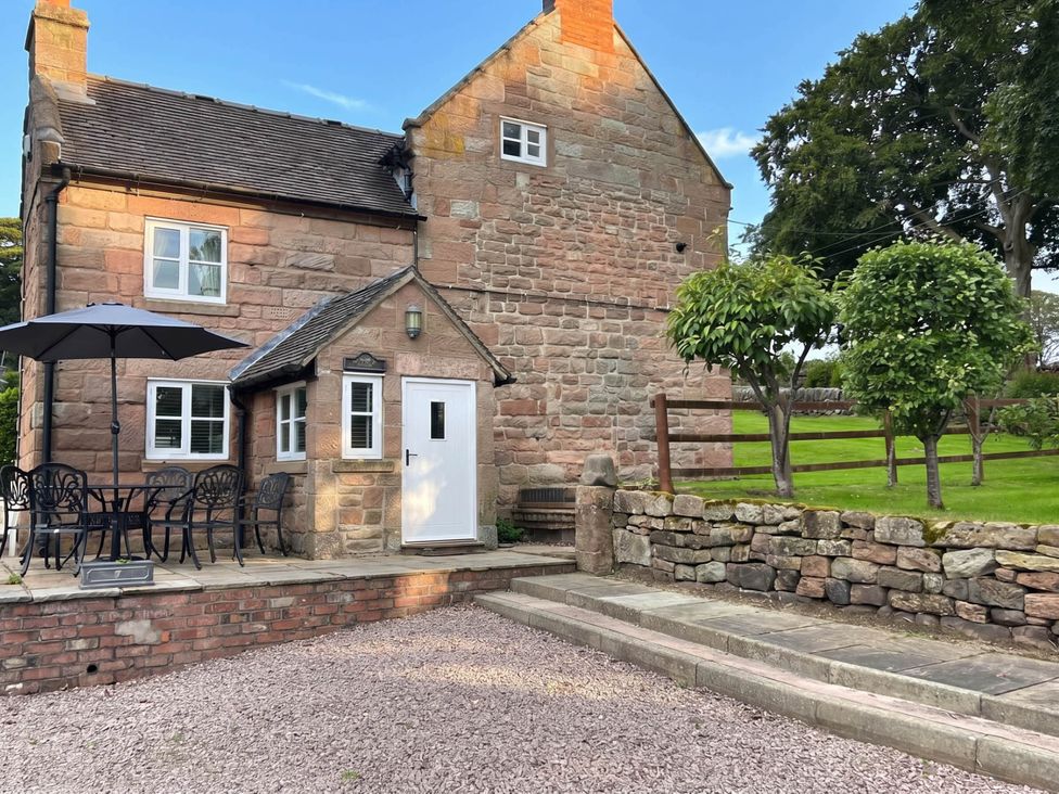 A house with a patio and seating area at Farmhouse Sleeps 5 Near Alton Towers Peak District Cheadle