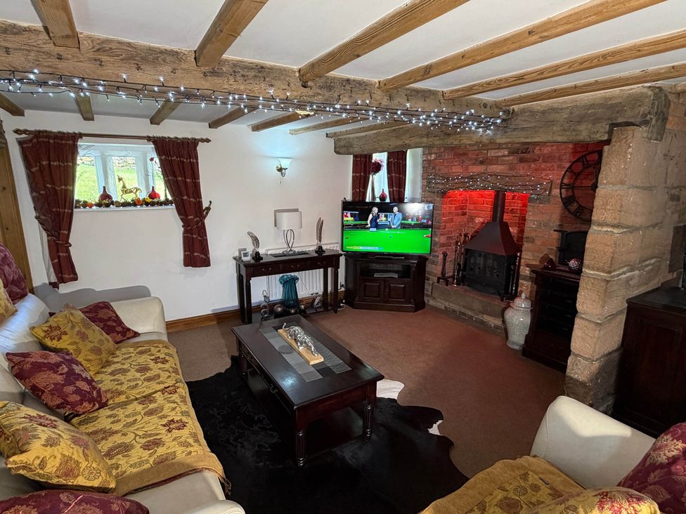 A living room with a TV and fireplace at Farmhouse Sleeps 5 Near Alton Towers Peak District in Cheadle
