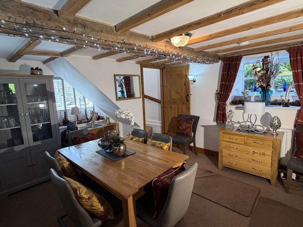 A dining room with a table and chairs at Farmhouse Sleeps 5 Near Alton Towers Peak District in Cheadle