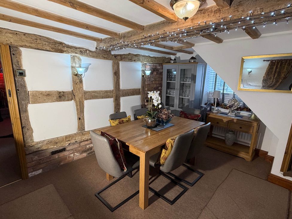 A dining room with a table and chairs at Farmhouse Sleeps 5 Near Alton Towers Peak District in Cheadle