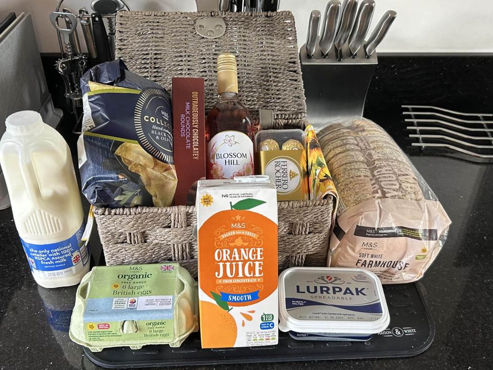 A kitchen counter with groceries including milk, eggs, and orange juice at Farmhouse Sleeps 5 Near Alton Towers Peak District Cheadle