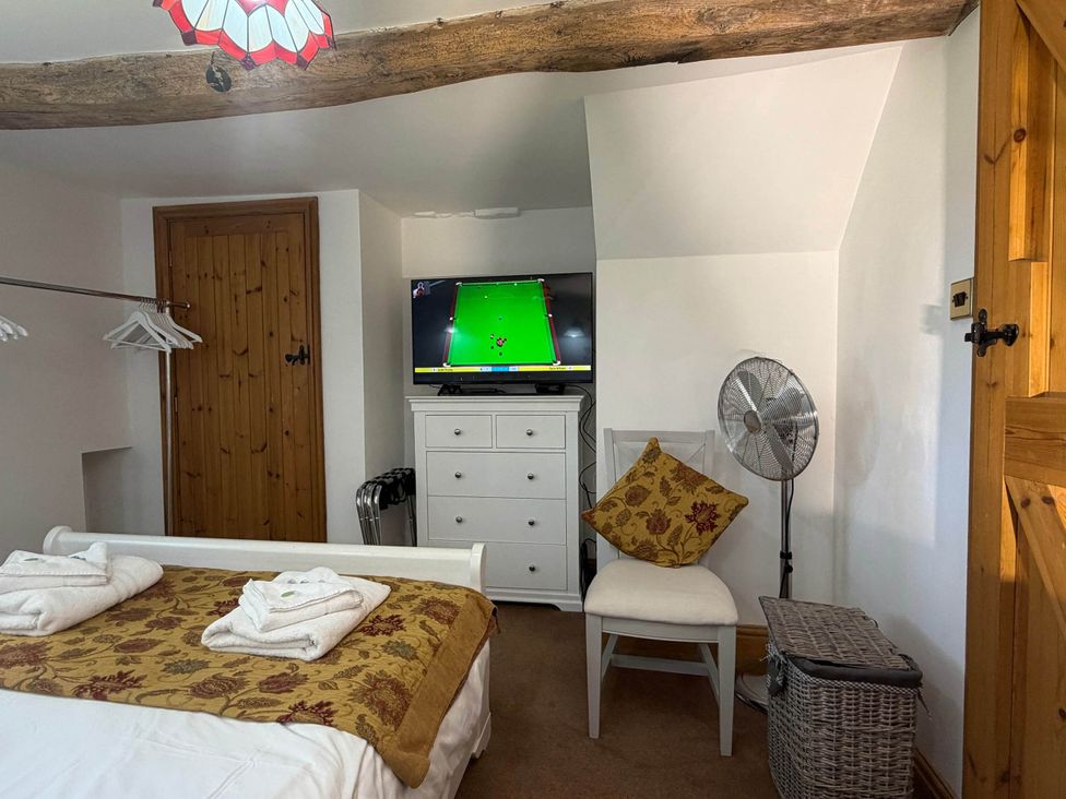 A bedroom with a bed and a television at Farmhouse Sleeps 5 Near Alton Towers Peak District, Cheadle