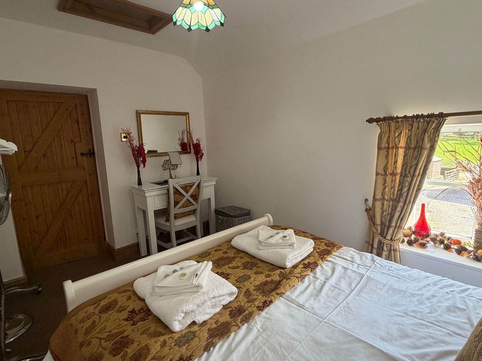 A bedroom with a bed and a mirror at Farmhouse Sleeps 5 Near Alton Towers Peak District, Cheadle