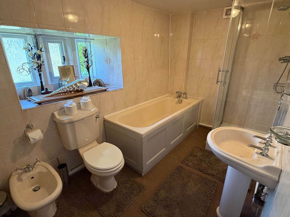 A bathroom with a bathtub, toilet, bidet and sink at Farmhouse Sleeps 5 Near Alton Towers Peak District, Cheadle