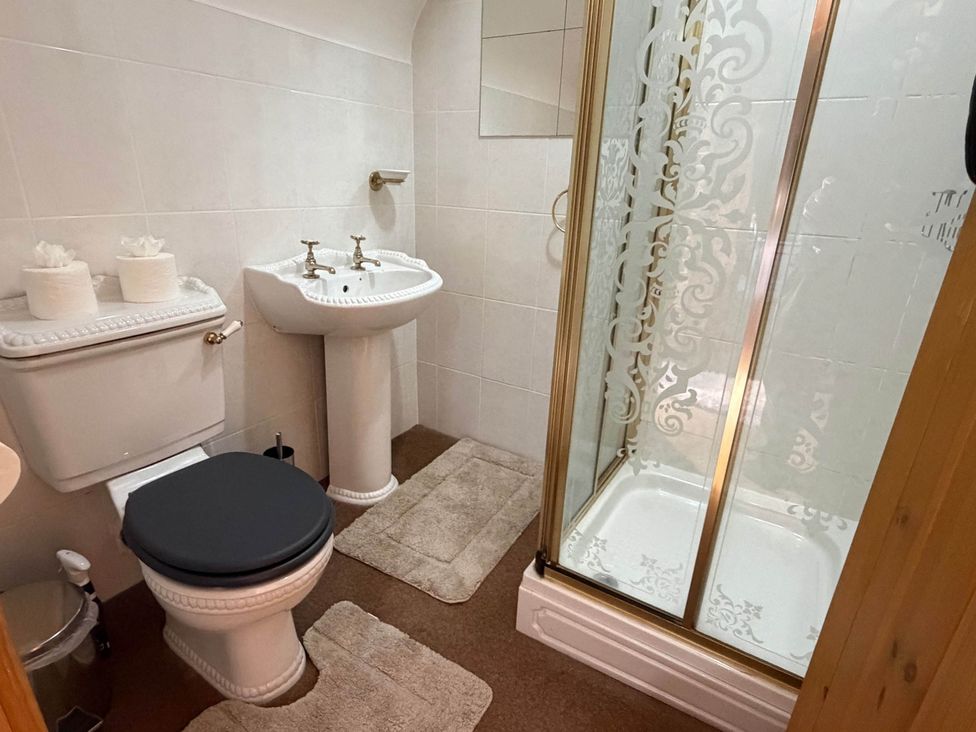 A bathroom with toilet, sink, and shower at Farmhouse Sleeps 5 Near Alton Towers Peak District in Cheadle