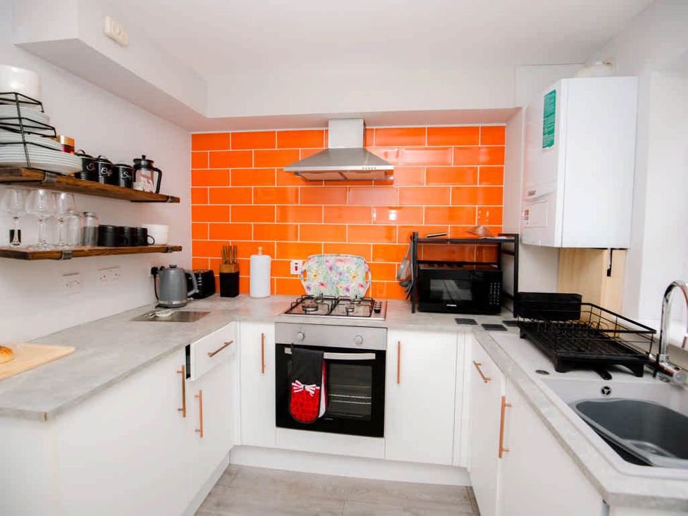 A kitchen with modern appliances and storage at House Sleeps 4 with Parking and Garden in Glastonbury