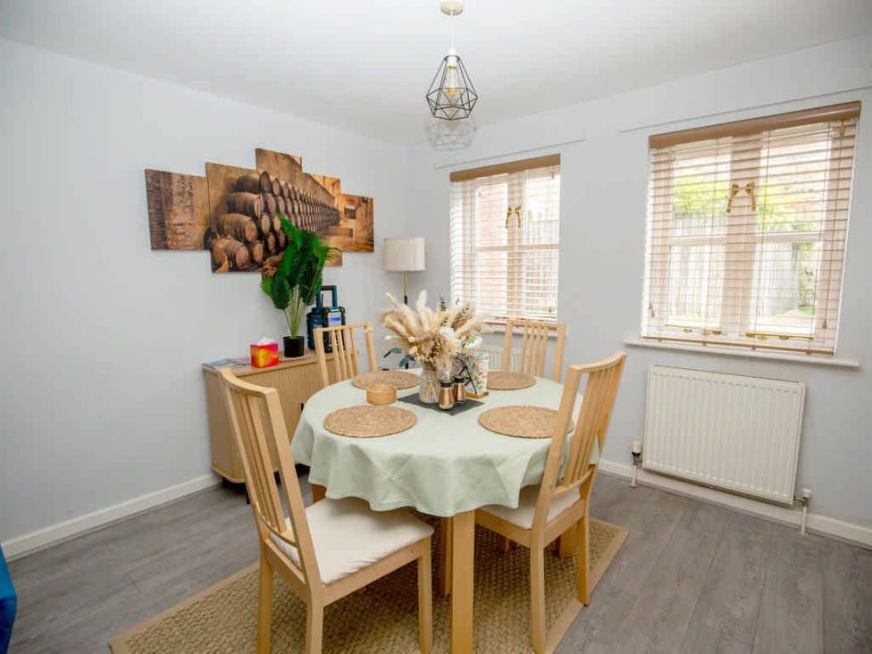 A dining room with a table and chairs at House Sleeps 4 with Parking and Garden Glastonbury