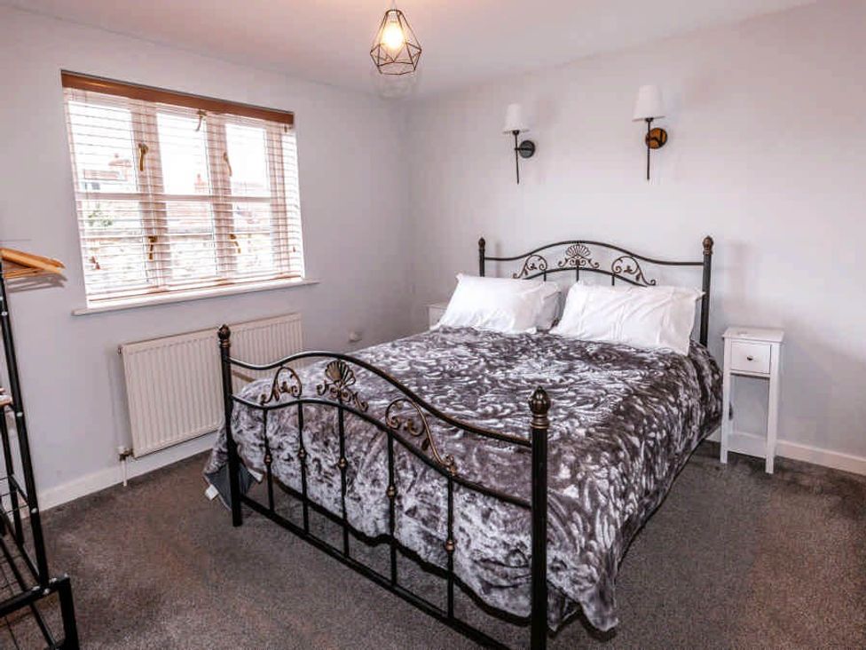 A bedroom with a bed and nightstand at House Sleeps 4 with Parking and Garden in Glastonbury