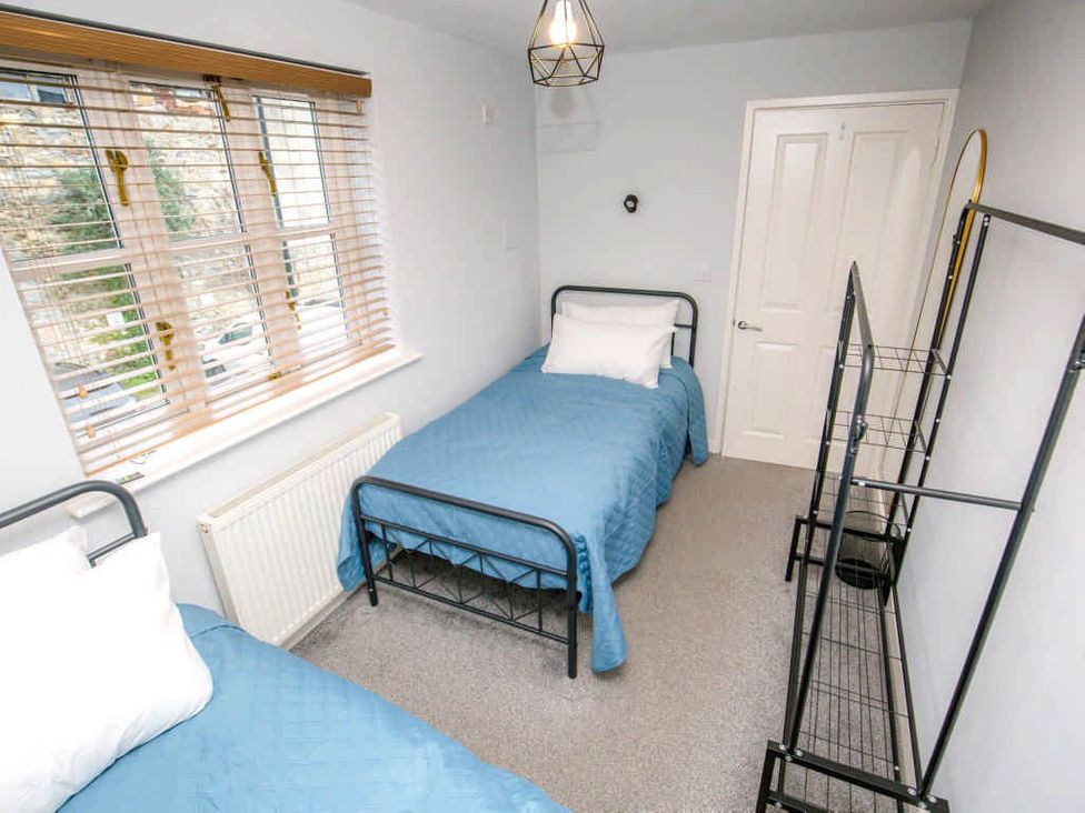 A bedroom with two beds and a shelf at House Sleeps 4 with Parking and Garden in Glastonbury