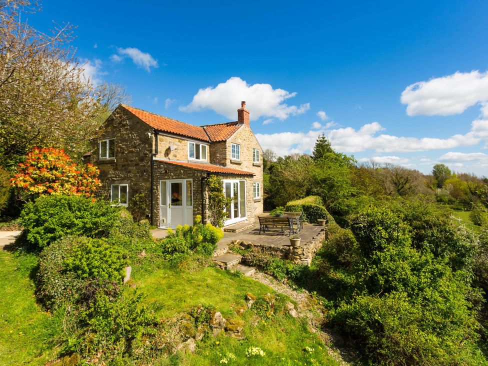 A cottage with a garden and patio at Stunning 3 Bedroom Cottage near Historic York, Ampleforth