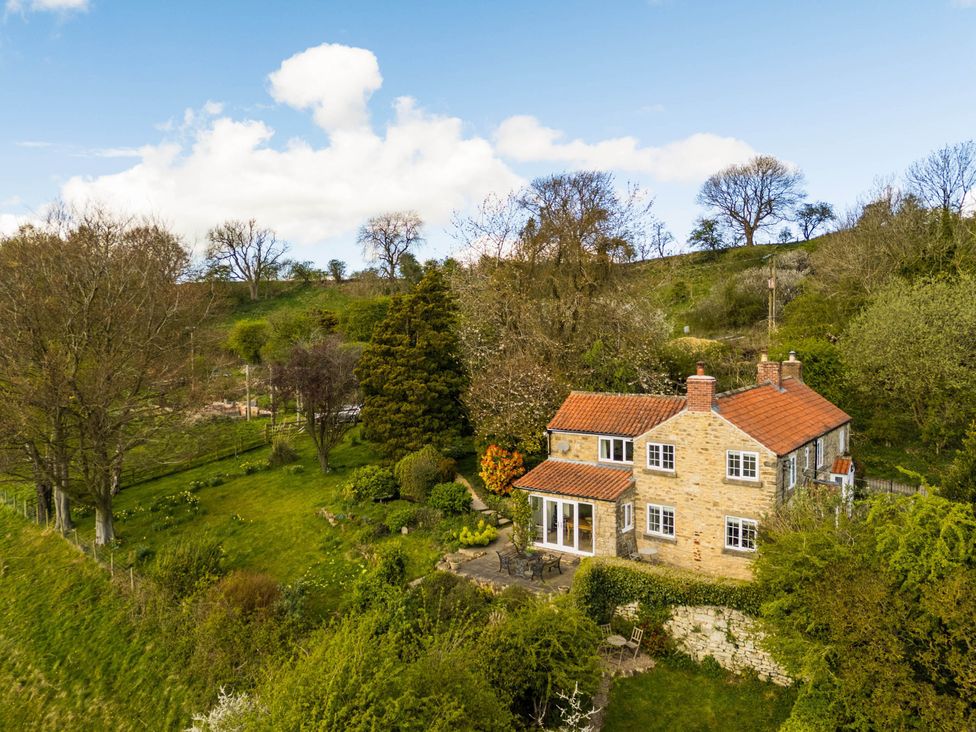 An outdoor view of a house with a garden at Stunning 3 Bedroom Cottage near Historic York in Ampleforth