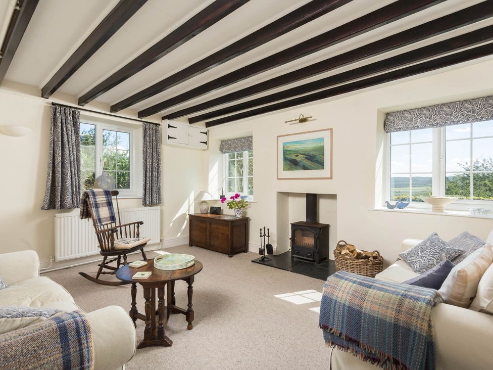A living room with a chair and table at Stunning 3 Bedroom Cottage near Historic York in Ampleforth