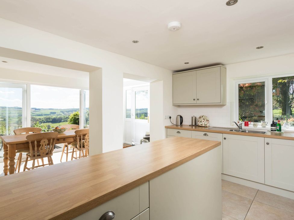 A kitchen with a countertop and dining table at Stunning 3 Bedroom Cottage near Historic York