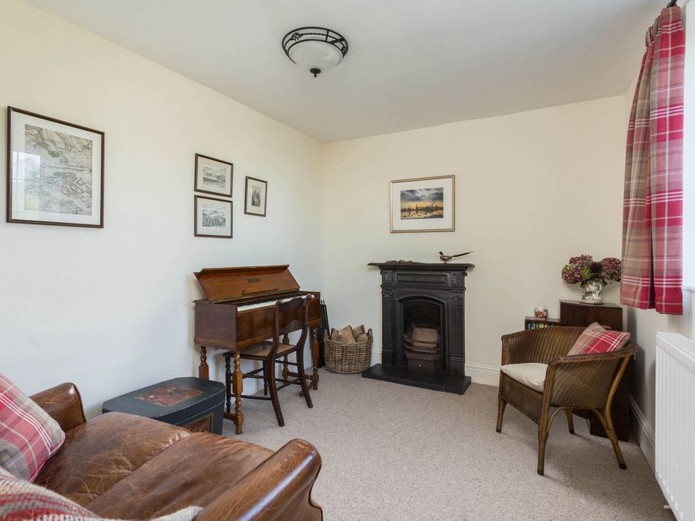 A living room with a sofa and piano at Stunning 3 Bedroom Cottage near Historic York in Ampleforth