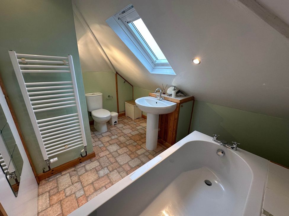 A bathroom with a bath, toilet, and sink at House Sleeps 8 Close to Beach Free parking, Mullion