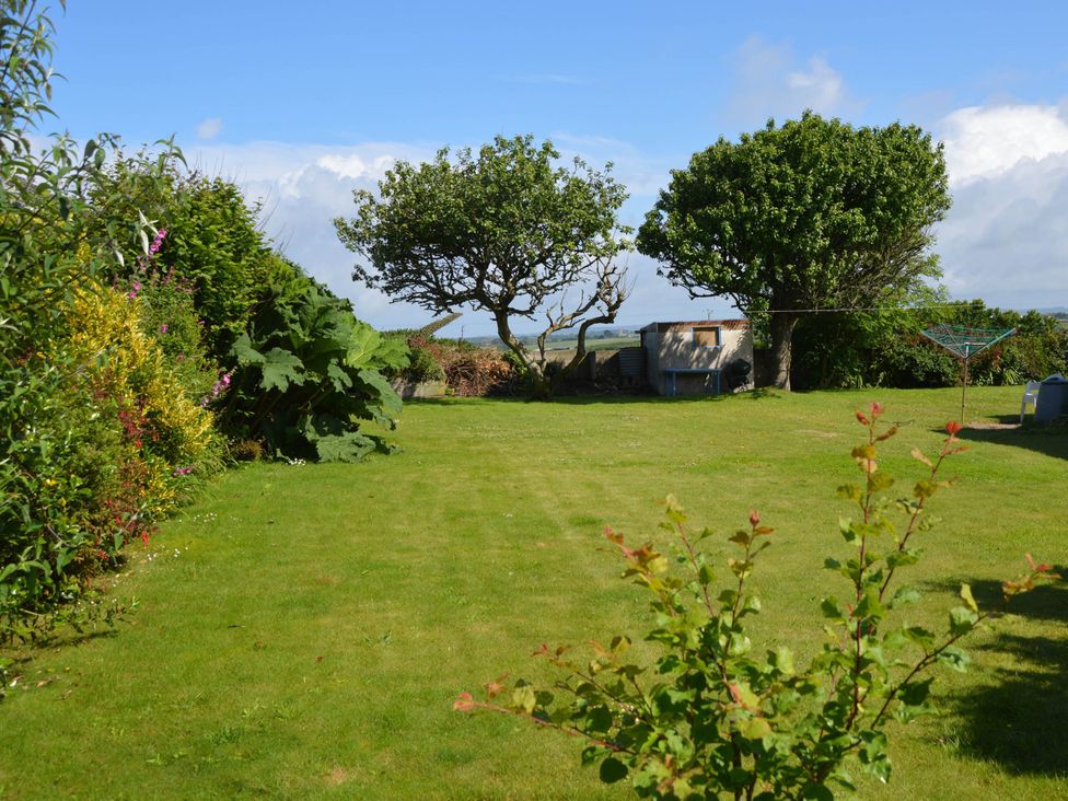 A garden with grass and trees at House Sleeps 8 Close to Beach Free parking Mullion