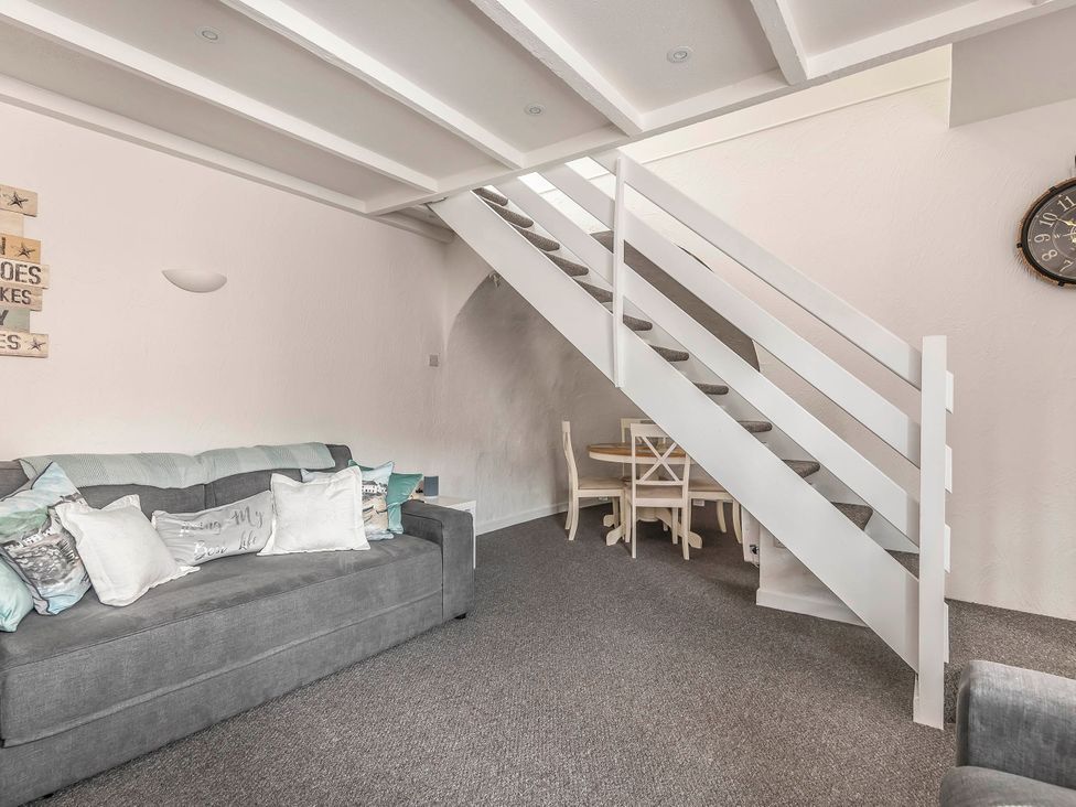 A living room with a sofa and a dining area at Cottage Sleeps 6 Pet friendly Patio in Saint Austell