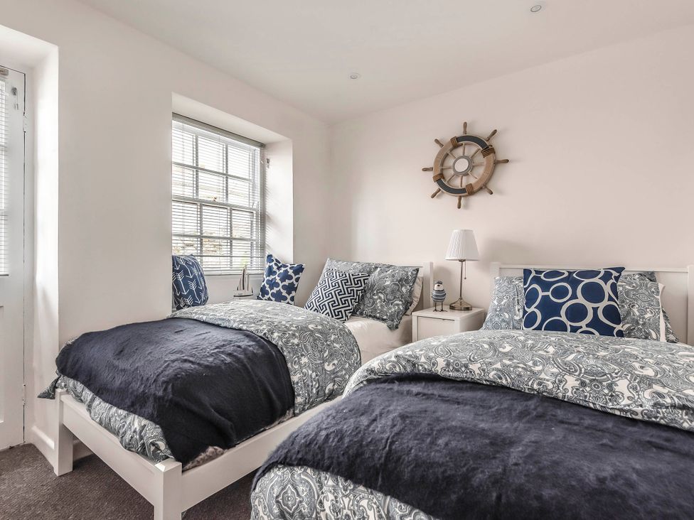 A bedroom with two beds and a nightstand at Cottage Sleeps 6 Pet friendly Patio in Saint Austell