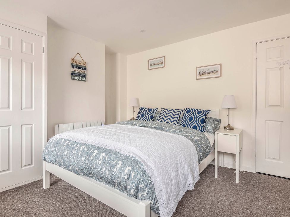 A bedroom with a bed and bedside table at Cottage Sleeps 6 Pet friendly Patio in Saint Austell