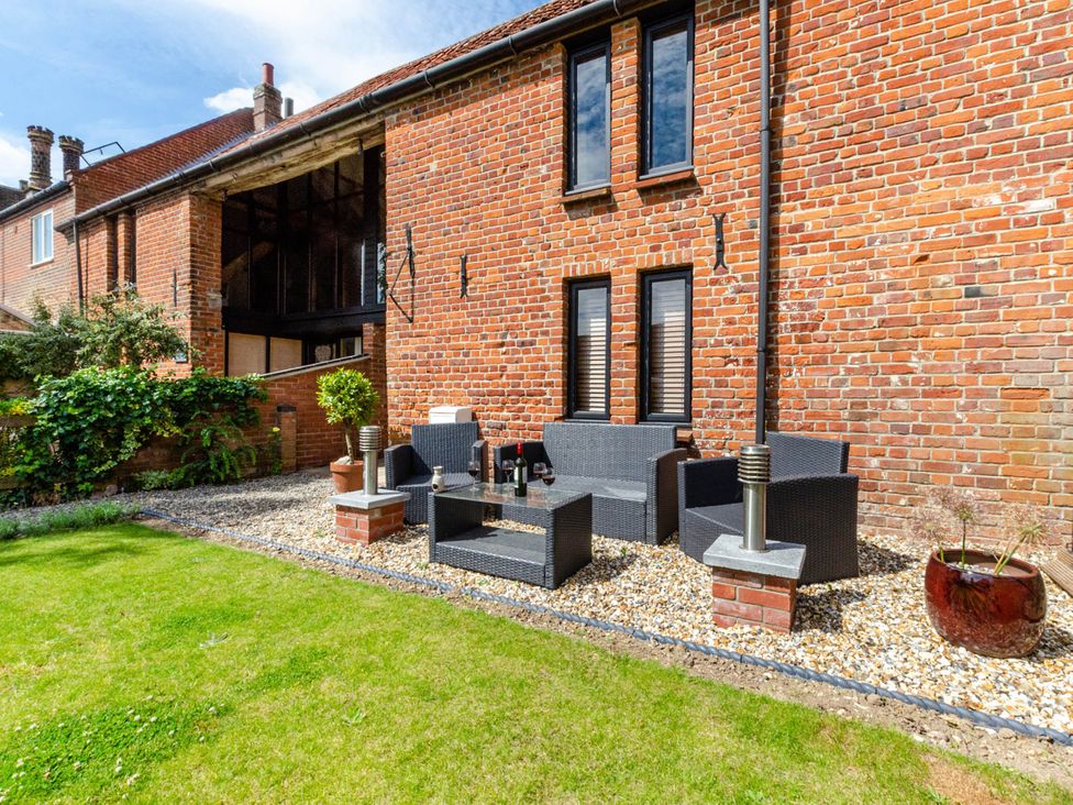 Outdoor seating area with a garden at 1880s Barn Conversion Sleeps4 Pet Friendly Hereford