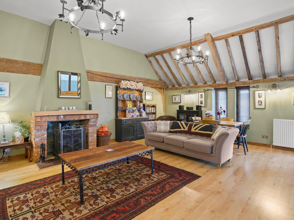 A living room with a fireplace and sofa at 1880s Barn Conversion Sleeps4 Pet Friendly Hereford