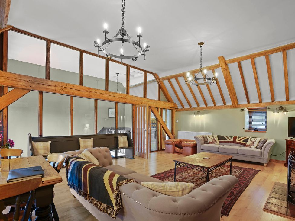 A living room with sofas and a dining table at 1880s Barn Conversion Sleeps4 Pet Friendly in Hereford