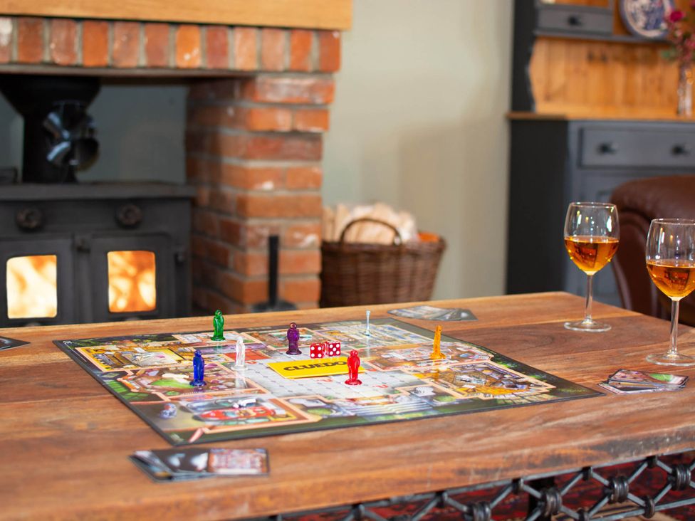 A board game with playing pieces and drinks on a table at 1880s Barn Conversion Sleeps4 Pet Friendly in Hereford