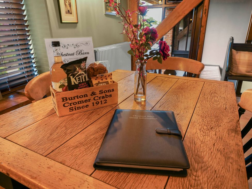 A dining room table with snacks and flowers at Chestnut Barn in Hereford
