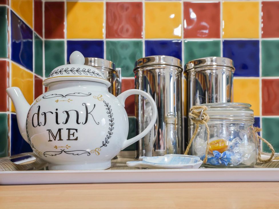 A teapot and canisters on a tray in a kitchen at 1880s Barn Conversion Sleeps4 Pet Friendly Hereford