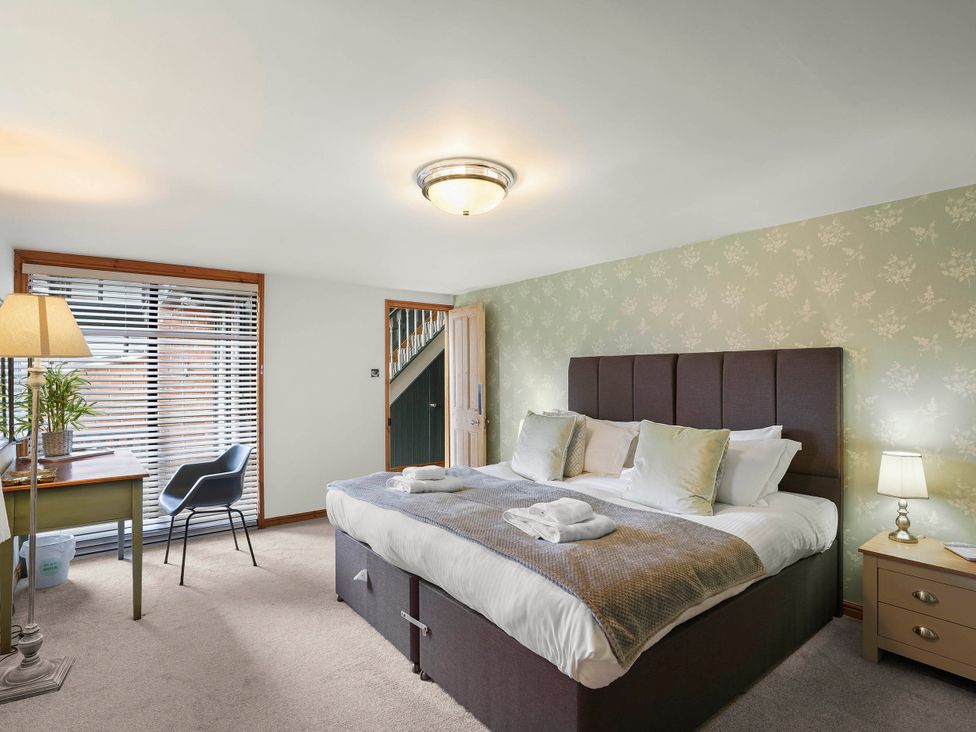 A bedroom with a bed and lamp at 1880s Barn Conversion Sleeps4 Pet Friendly Hereford