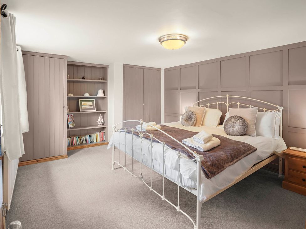 A bedroom with a bed and shelves at 1880s Barn Conversion Sleeps4 Pet Friendly in Hereford