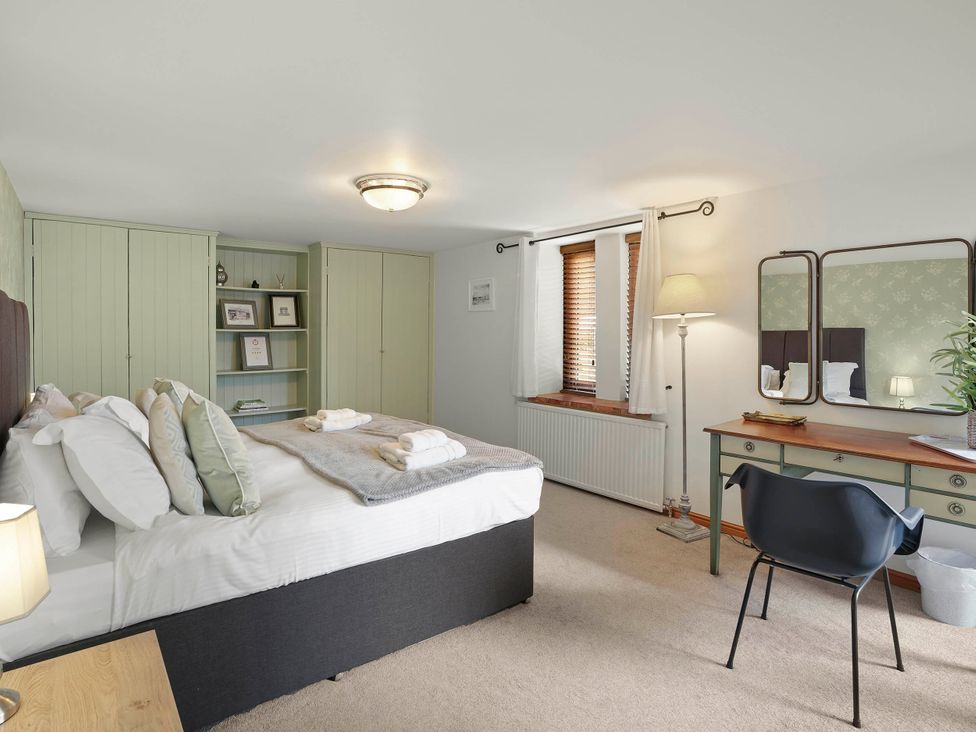 A bedroom with a bed and desk at 1880s Barn Conversion Sleeps4 Pet Friendly in Hereford