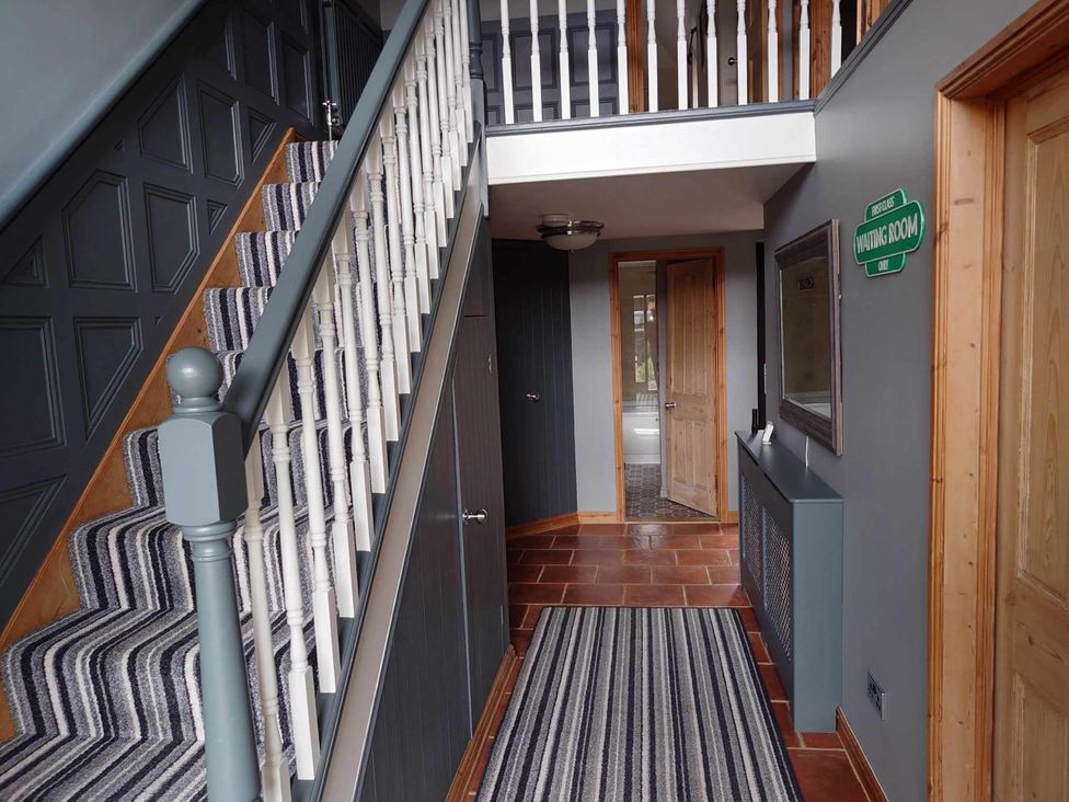 A hallway with stairs and a door at 1880s Barn Conversion Sleeps4 Pet Friendly Hereford