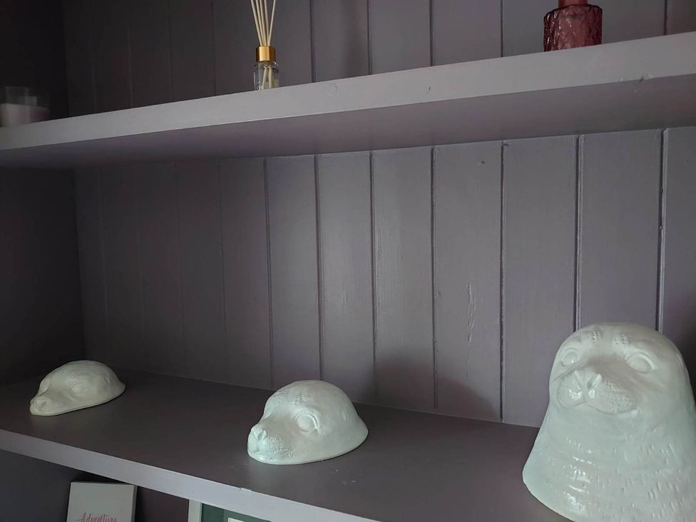 A shelf with ornaments and a diffuser at 1880s Barn Conversion Sleeps4 Pet Friendly Hereford