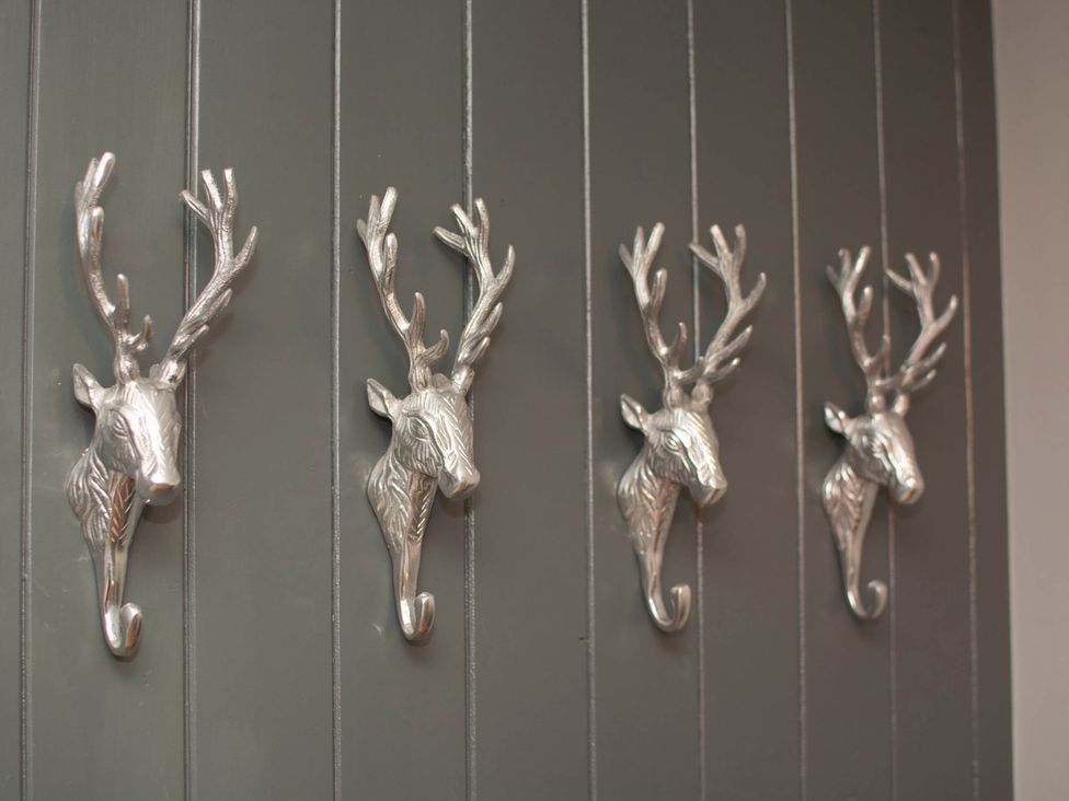 A wall with decorative deer head hooks at 1880s Barn Conversion Sleeps4 Pet Friendly Hereford