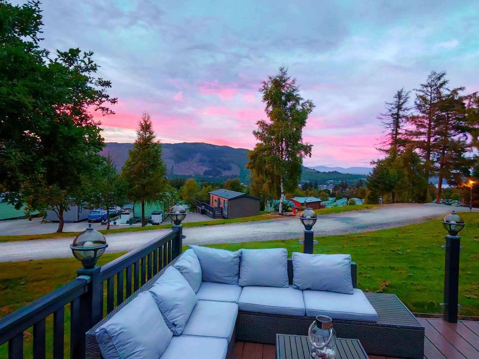 An outdoor seating area with a couch and trees at Dunoon 3Bed Lodge Sleeps 6 Pet Friendly near Dunoon