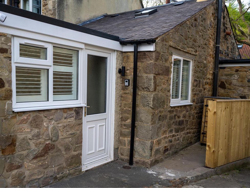 An entrance with a door and windows at High Spec 1Bed Cottage in Staindrop