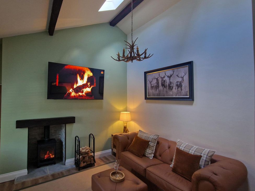 A living room with a television above a fireplace at High Spec 1Bed Cottage in Staindrop