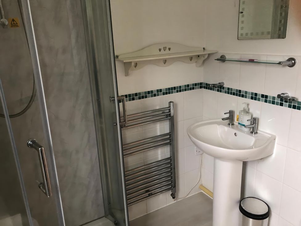 A bathroom with a shower cubicle and wash basin at Cosy 3 Bedroom House on Cornish estate with pool in St Tudy