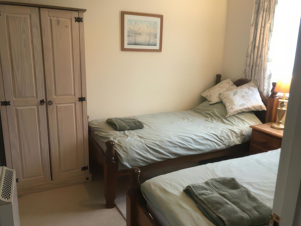 A bedroom with two beds and a wardrobe at Cosy 3 Bedroom House on Cornish estate with pool, St Tudy